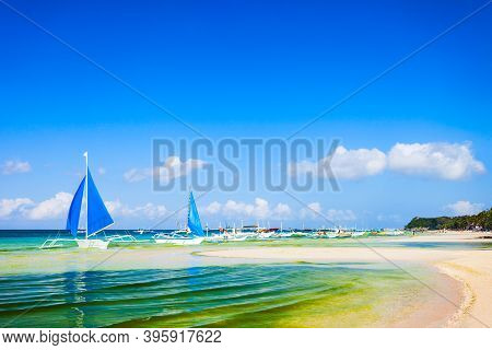 Traditional Filipino Boat At The Idyllic White Sand Beach At Boracay Island In Philiphines