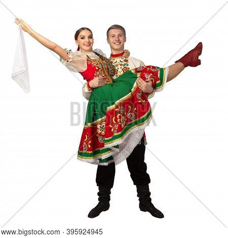 Beautiful Caucasian Cuple Dancing In Russian Folk Costumes Isolated On White Background. Full Length