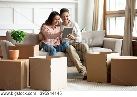 Couple Using Tablet Buy Goods Online Relocated At New Home