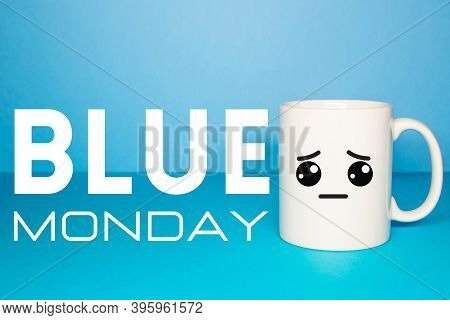 Close-up Of A White Mug On A Blue Background Looking Sad. Concept Of Sadness Caused By Covid-19, New