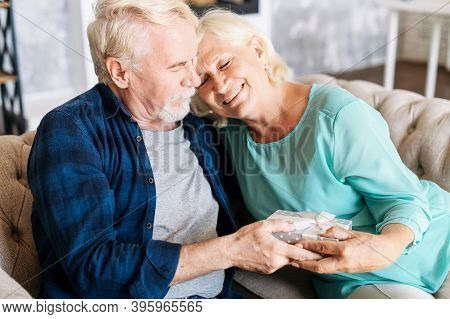 Elderly Couple Has Anniversary Or Celebrates Some Important Date. Senior Gallant Man Is Giving A Gif
