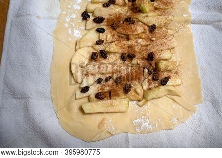Apfelstrudel Assembly Step On Rolled Dough: The Apple Slices And Raisins Are Placed On The Layer Sur