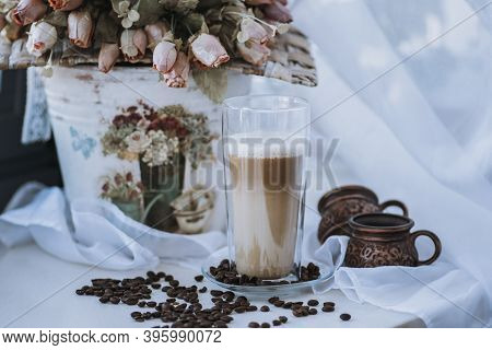 A Cup Of Cappuccino With Coffee Bean As Background