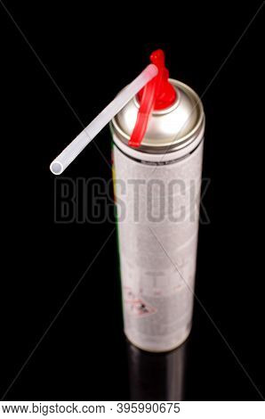 Polyurethane Foam Sprayer Adhesive Isolated On The Black Reflective Background. Product For Sealing 