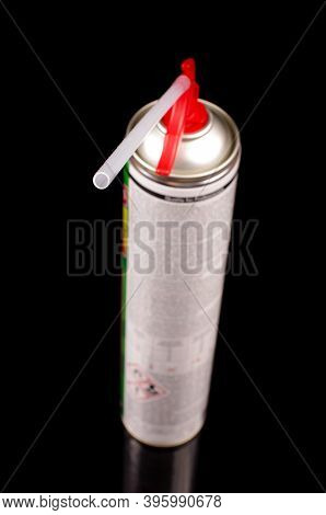 Polyurethane Foam Sprayer Adhesive Isolated On The Black Reflective Background. Product For Sealing 