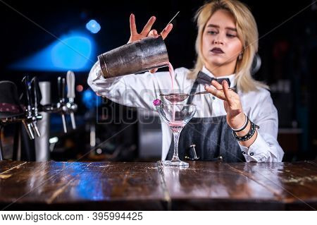 Focused Girl Tapster Demonstrates His Skills Over The Counter