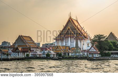 Wat Kanlayanamit In Bangkok, Thailand As Seen From The Boat Cruising The Chao Phraya River