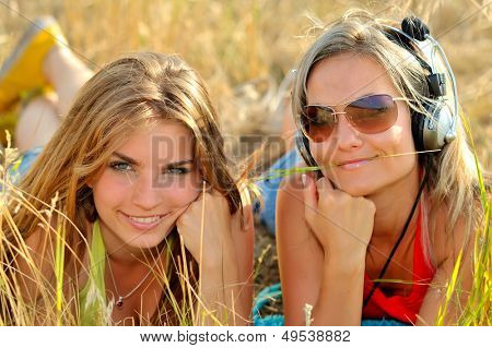 beautiful happy women on field in summer