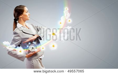 Businesswoman holding alarmclock
