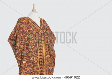 Traditional African dashiki on tailor's dummy over gray background
