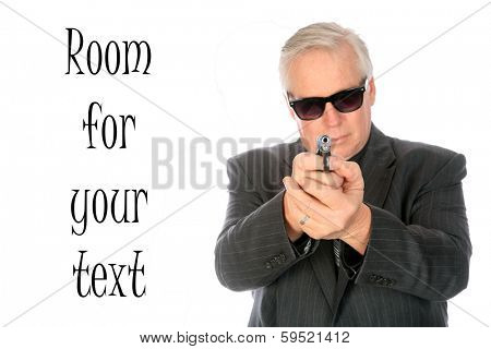 A very good looking well dressed business man in a suit brandishes a small pistol while wearing dark sunglasses. Isolated on white with room for your text. He could be a CIA Mole or Mob Lackey. 