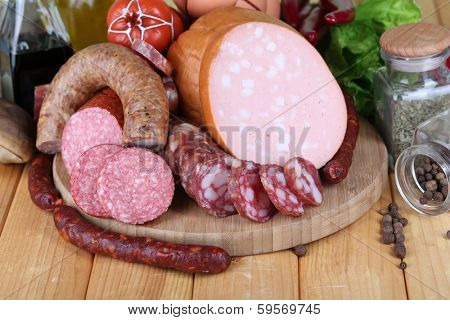 Different sausages on wooden table close-up