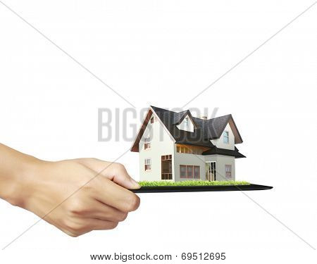 house on ,touch- tablet in a hands 