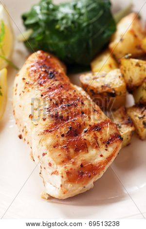 Grilled chicken breast with roasted potato and chard