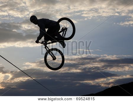 BONTIDA - JUNE 21: Unidentified BMX rider making a bike jump during the BMX Competition, at Electric Castle Festival on June 21, 2014 in the Banffy castle in Bontida, Romania
