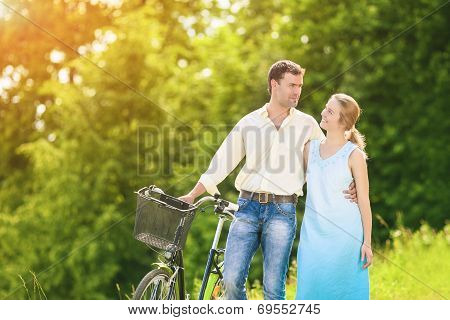 Portrait Of  Caucasian Couple Having A Stroll In Park With Bike. Relationships Concept. Horizontal I