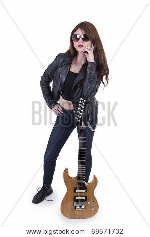 Beautiful rebel young girl posing with electric guitar