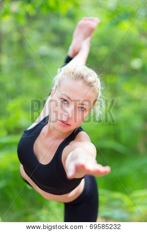 Lady practicing yoga in the nature.