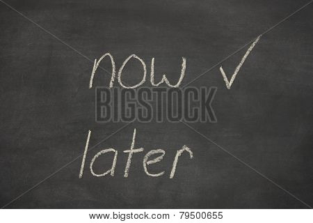 Now Later Written On A Chalk Board / Blackboard