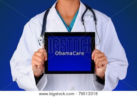 Closeup of a female medical professional holding a tablet computer with a blue screen with the words ObamaCare. Person is unrecognizable on a blue light to dark background.