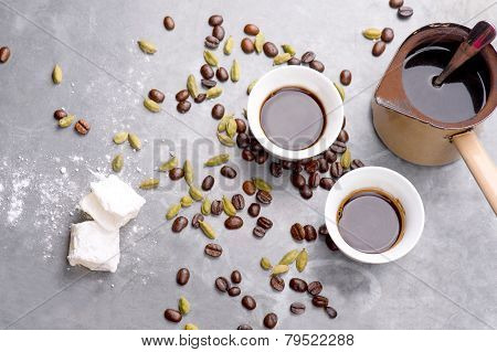 Turkish Coffee with coffee beans and Cardamom scattered on a vintage background