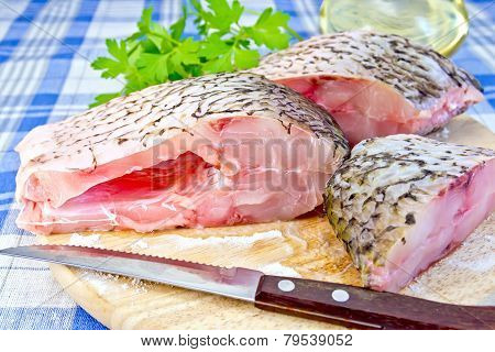 Bream raw with parsley on fabric