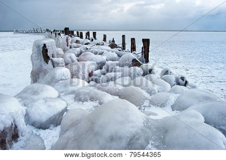 Frozen Old Pier With Stones