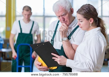 Supervisor Talking With Storage Worker
