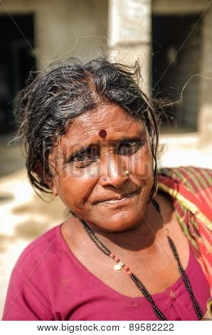 HAMPI, INDIA - 01 FEBRUARY 2015: Indian middle-aged woman with bindi on street infront of home