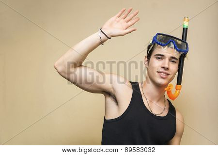 Young scuba diver wearing diving mask saying hello