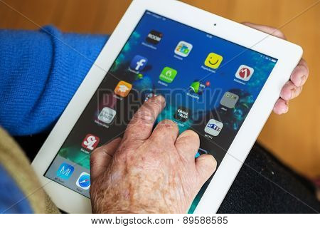 Senior Woman Using Tablet With Many App On A Ipad Screen