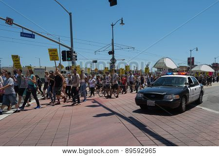 Police Watching Protestants In The Streets With Signs