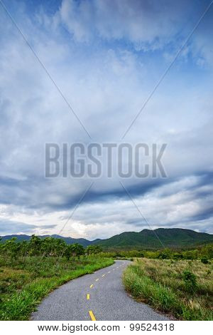 Road running through green hills in rainny season.Thailand.