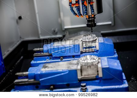 Metalworking CNC milling machine. Cutting metal modern processing technology. Small depth of field. Warning - authentic shooting in challenging conditions. A little bit grain and maybe blurred.