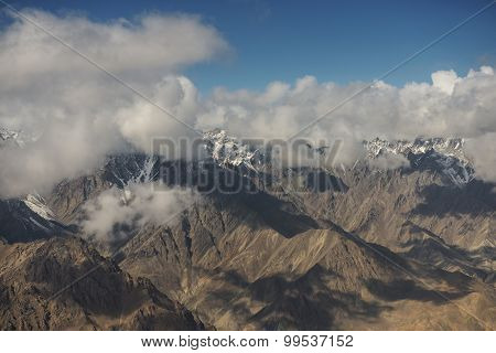 Aerial view of desert and high mountain from the airplane window. New Delhi-Leh flight ,India.