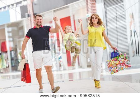 Happy family with shopping bags at the mall