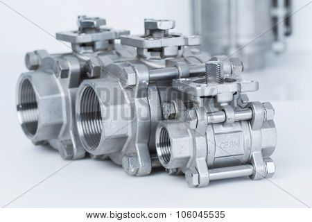 Group 3 valves different sizes ball valve with selective focus on thread fittings