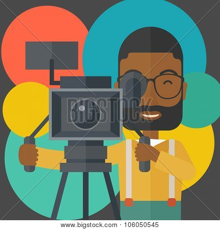 An african-american cameraman with beard and glasses looking through movie camera on a tripod vector flat design illustration. Square layout.