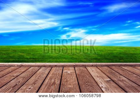 Rustic Wooden Boardwalk And Open Grassfield