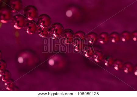 Christmas Pink Garland Made From Small  Beads.on A Rosy Background. New Year Toy. Toned