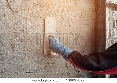 Plasterer Concrete Worker At Wall Of Home Construction Building