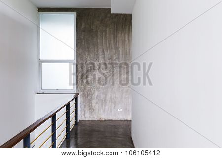 Architecture Design Of House, Passageway Cement Floor And White Wall With Baluster In Modern Room