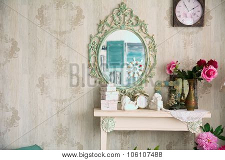 Vintage Interior With Mirror And A Table With A Vase And Flovers