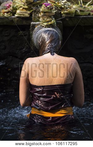 Traveller take a bath at Holy Spring Water Tirta Empul Hindu Temple , Bali Indonesia.