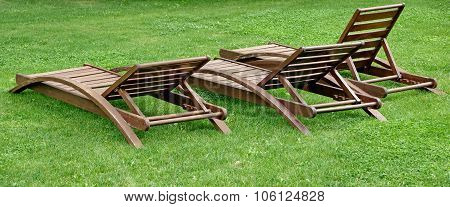 Empty Wooden Weathered Lounger On The Lawn At The Evening