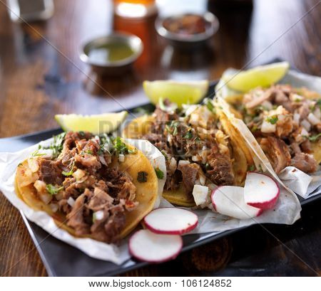 mexican tacos with limes and radish slices