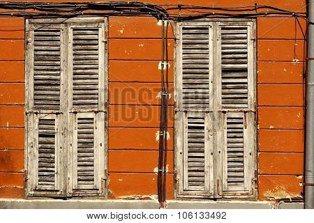 Two Dirty Wooden Closed Shutters In The Old Building Facade