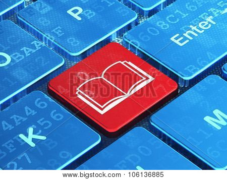 Learning concept: Book on computer keyboard background