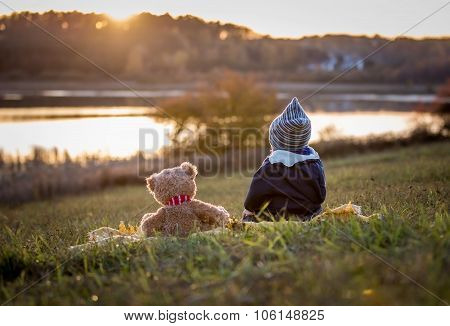 Boy And Teddy Bear Watching Sunset
