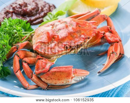 Seafood dish - cooked crab with lemon and herbs.